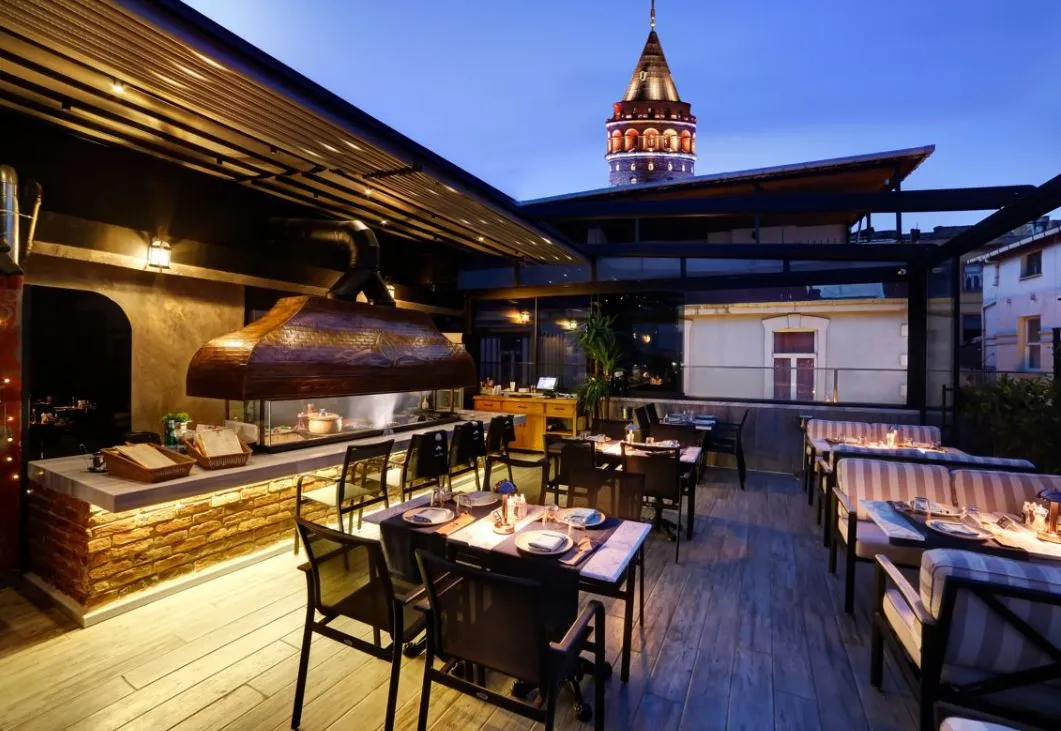Moise Karaköy rooftop terrace with its charcoal grill and Galata Tower behind