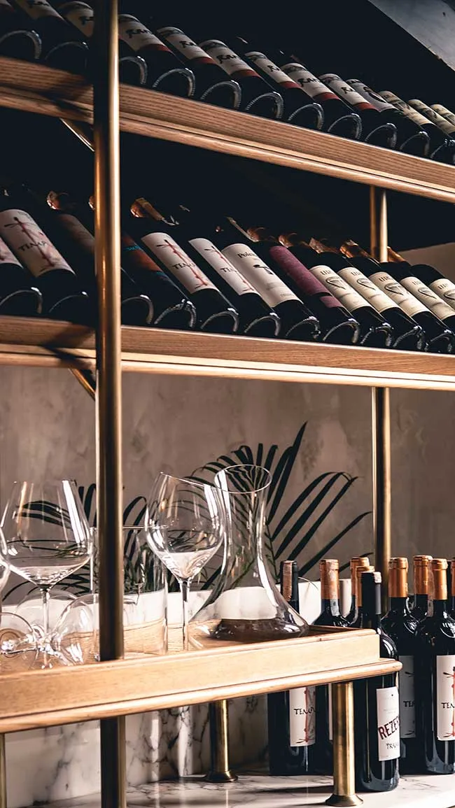 Wine shelves and glassware at the bar