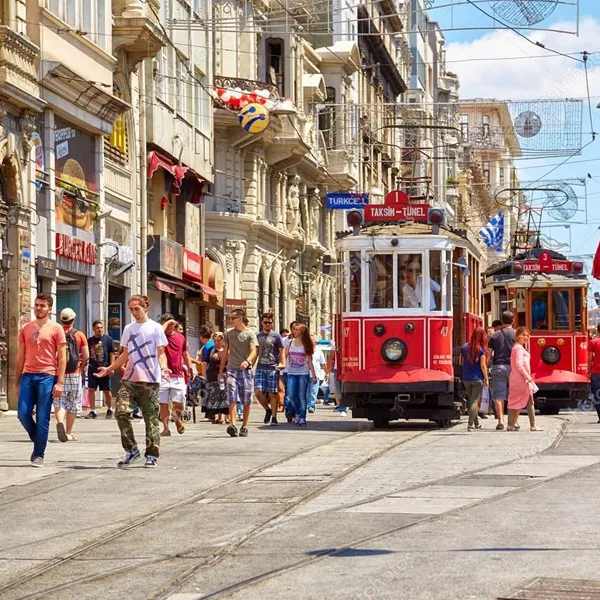 Red nostalgic tram on busy İstiklal Street