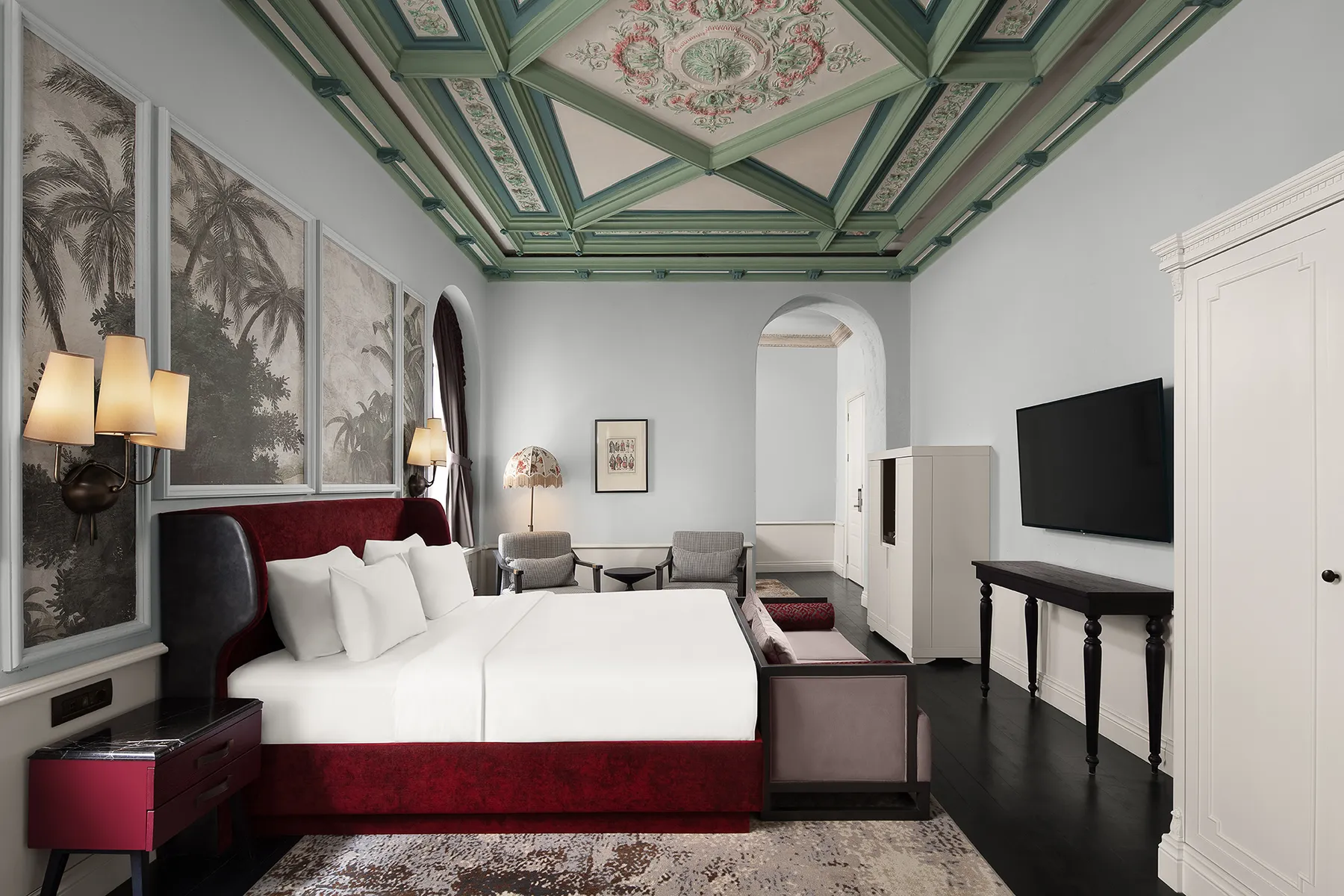 Guest room under a painted historic ceiling