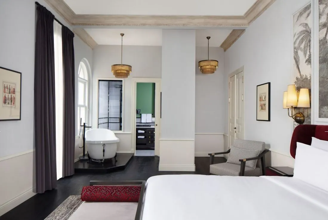 Suite bedroom with a freestanding bathtub