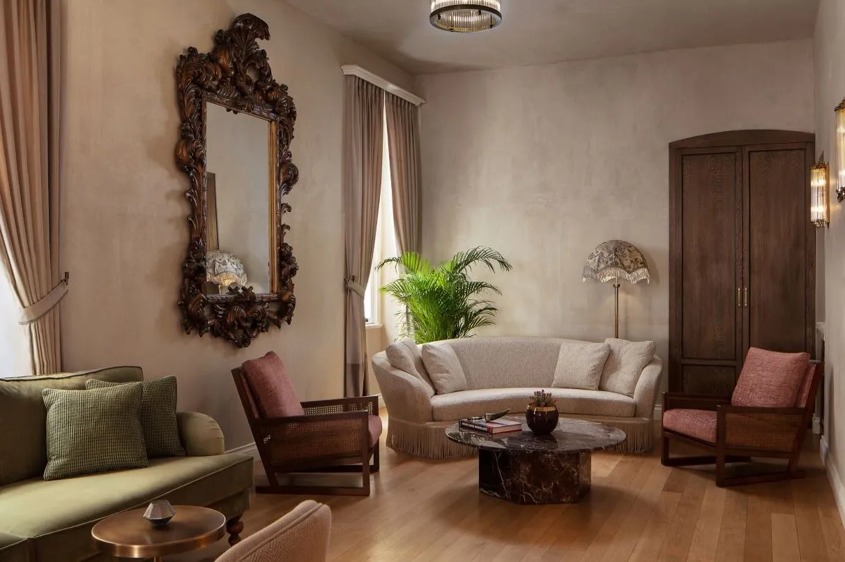 Lounge with a carved mirror, sofas and palms