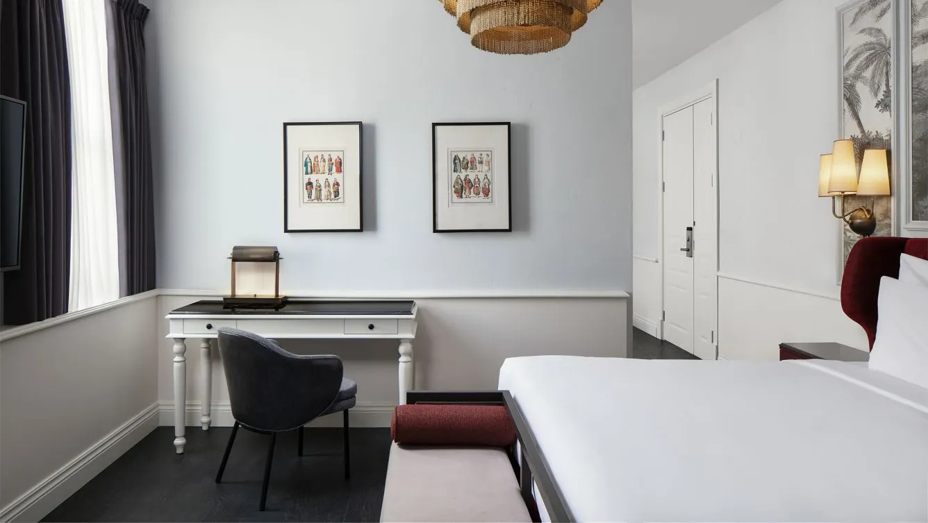 Camondo Suite with a king bed, writing desk and framed prints