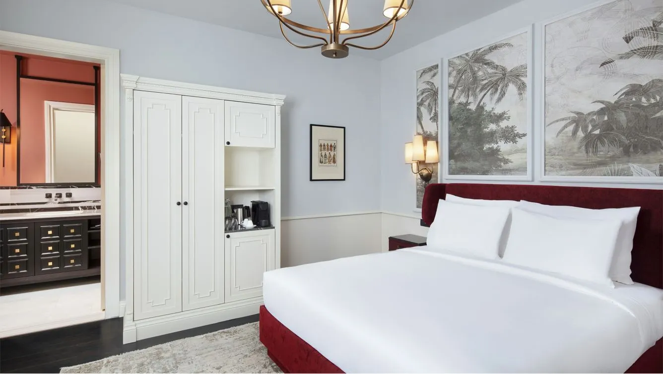 Standard room with a queen bed, wardrobe and painted wall panels
